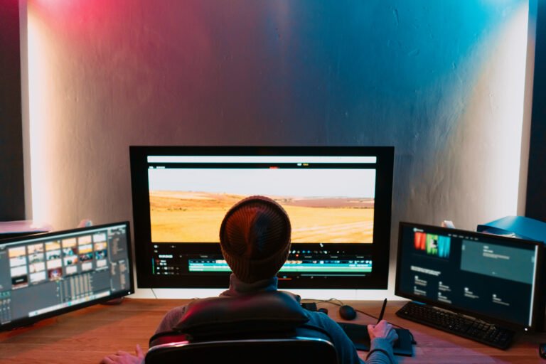 Male Video Editor Working on His Personal Computer with Big Display